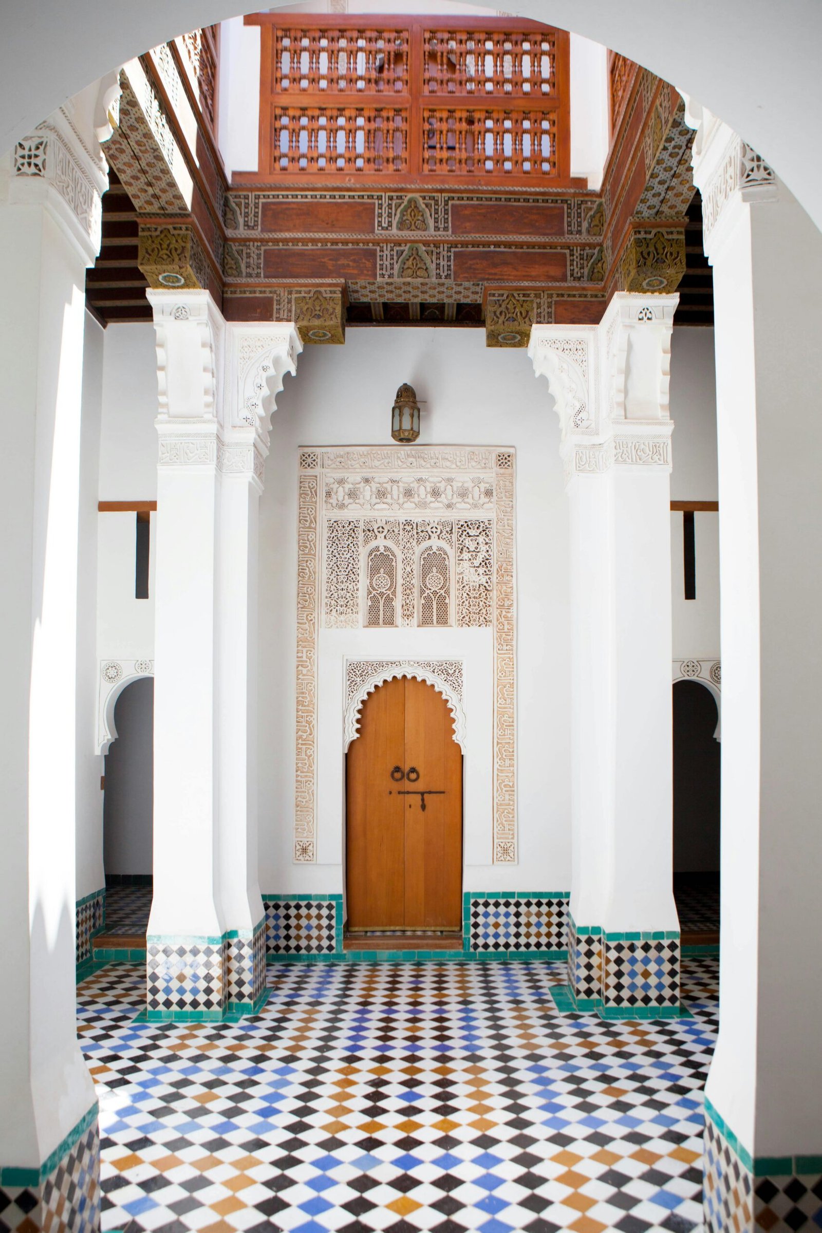 Stunning Moroccan interior with intricate designs and colorful tiles in a Marrakech building.